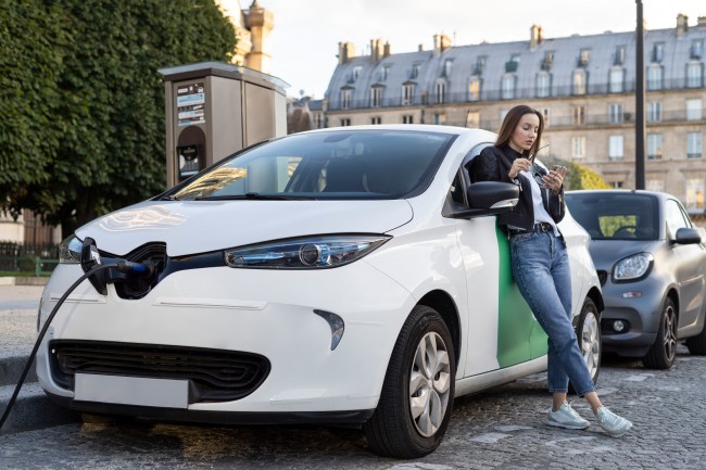 Women Checking Electric Car Tax